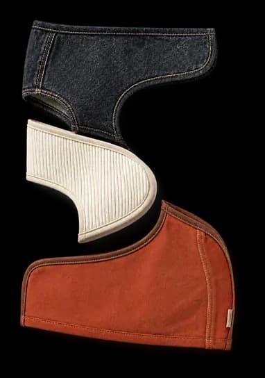 Denim, ivory and clay panels layered into a single curve