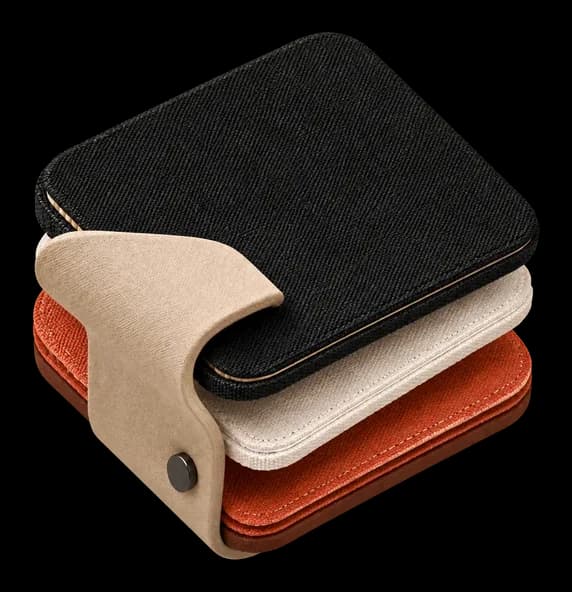 Folded denim, sand and clay textiles stacked in an S